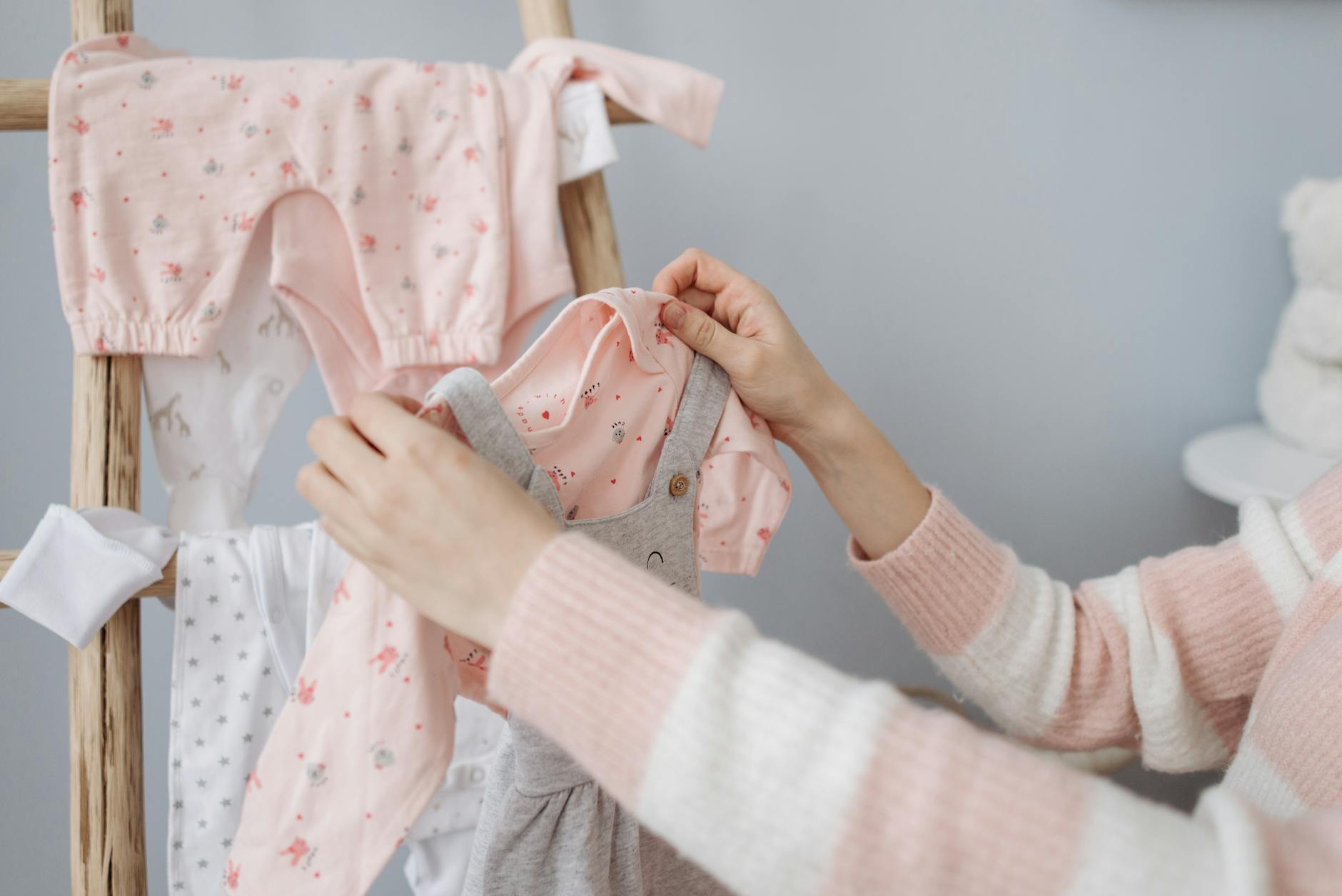 a person holding a baby clothing